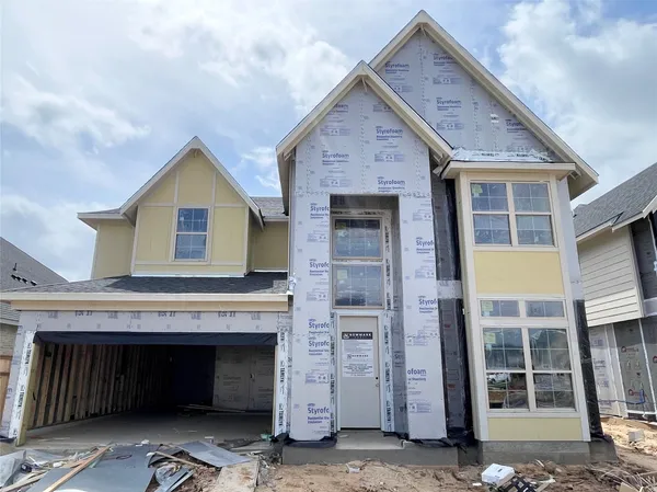 a view of a house with a garage and balcony