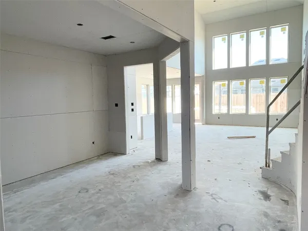 a view of a room with wooden floor and white walls
