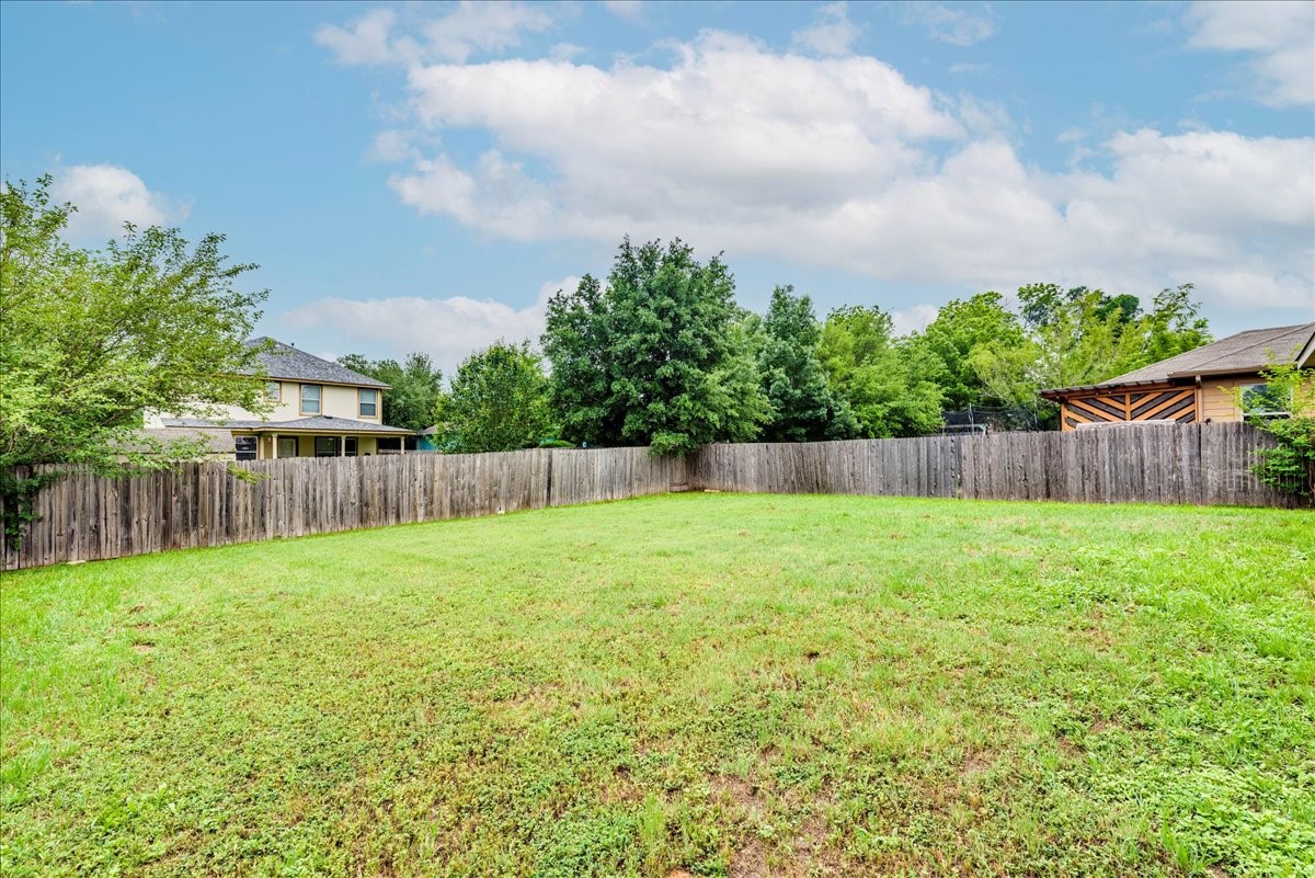 1061 Violet Lane Kyle, TX 78640 - Photo 24 of 34 view of lawn and fenced in back yard