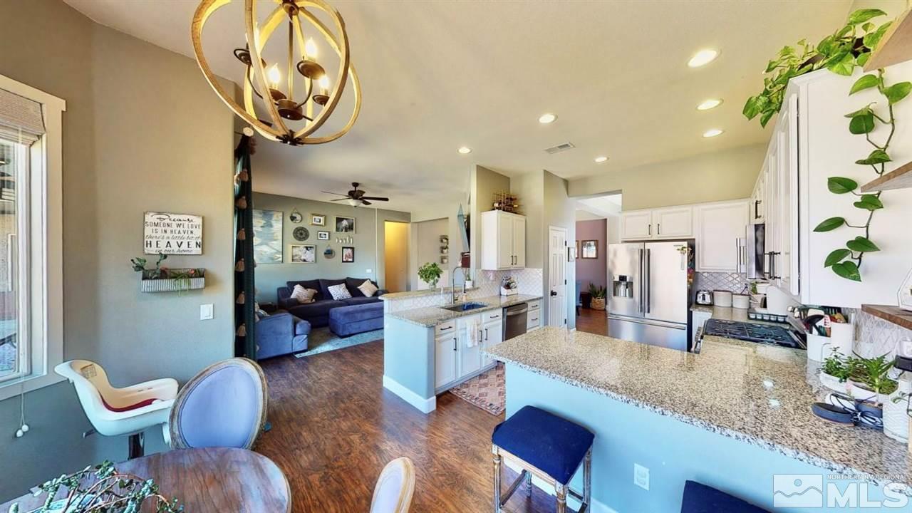 10621 Copper Moon Court Reno, NV 89521 - Photo 13 of 33 a living room with kitchen island furniture and a chandelier