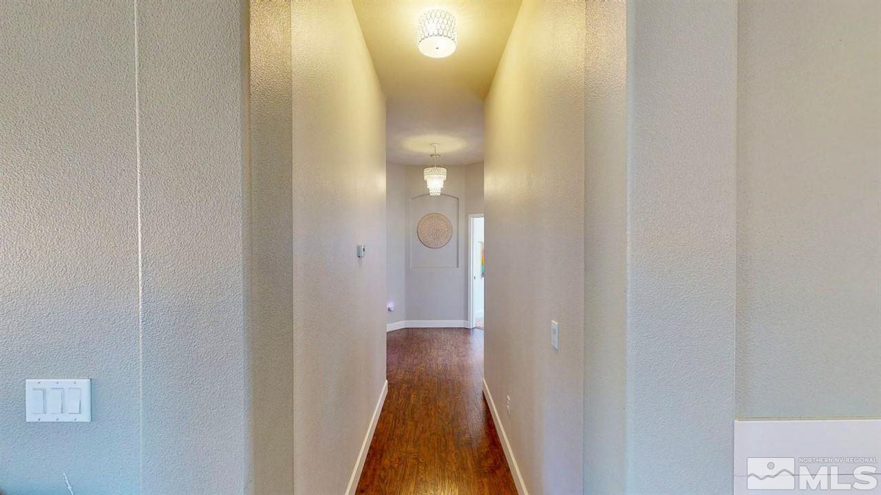 10621 Copper Moon Court Reno, NV 89521 - Photo 17 of 33 a view of a hallway with wooden floor