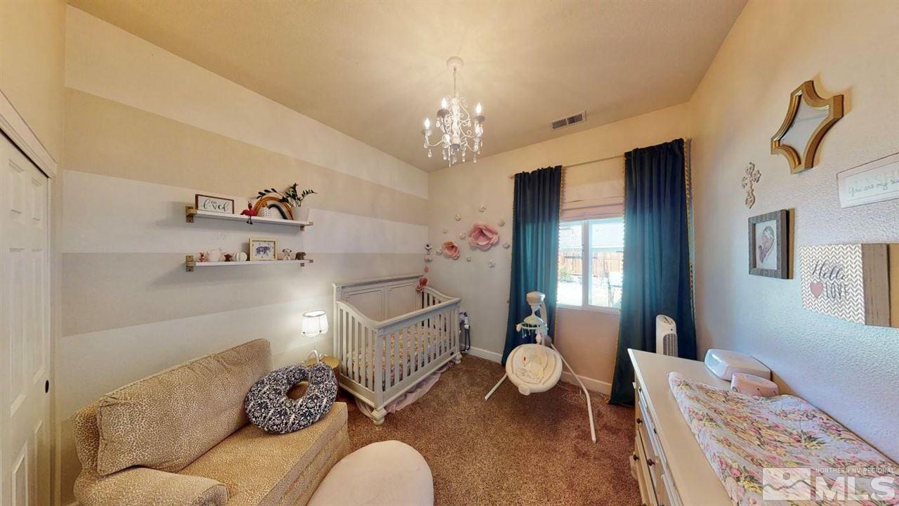 10621 Copper Moon Court Reno, NV 89521 - Photo 19 of 33 a living room with furniture and a chandelier