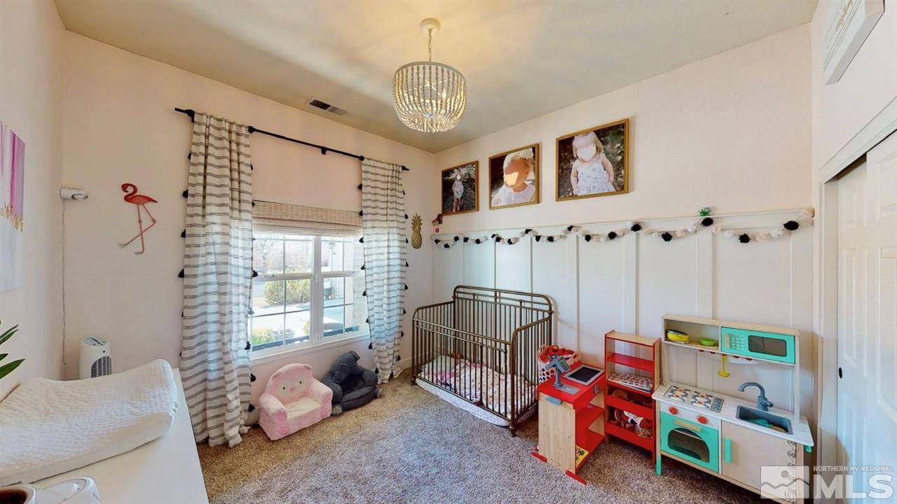 10621 Copper Moon Court Reno, NV 89521 - Photo 20 of 33 a living room with baby crib furniture and a window