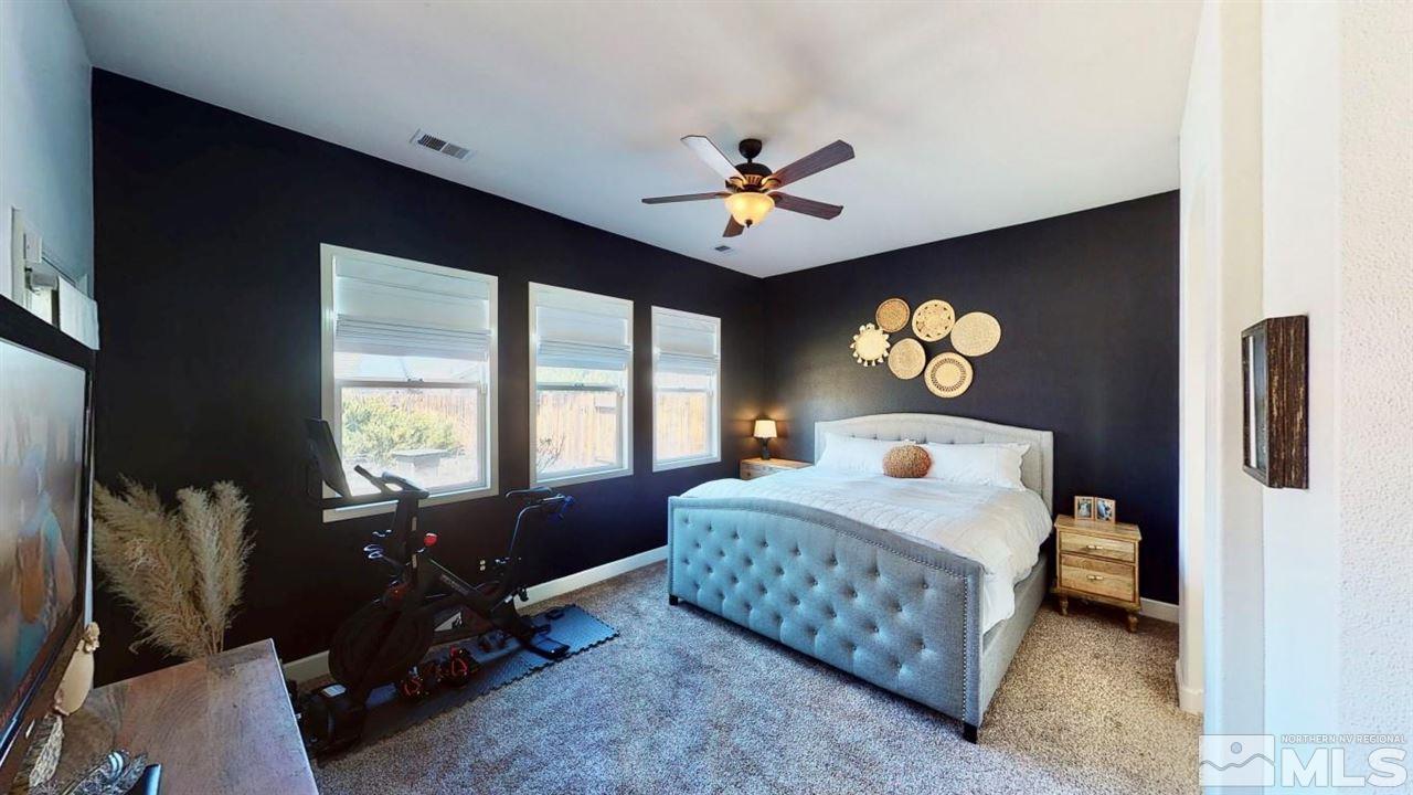 10621 Copper Moon Court Reno, NV 89521 - Photo 23 of 33 a bedroom with a bed furniture and a window