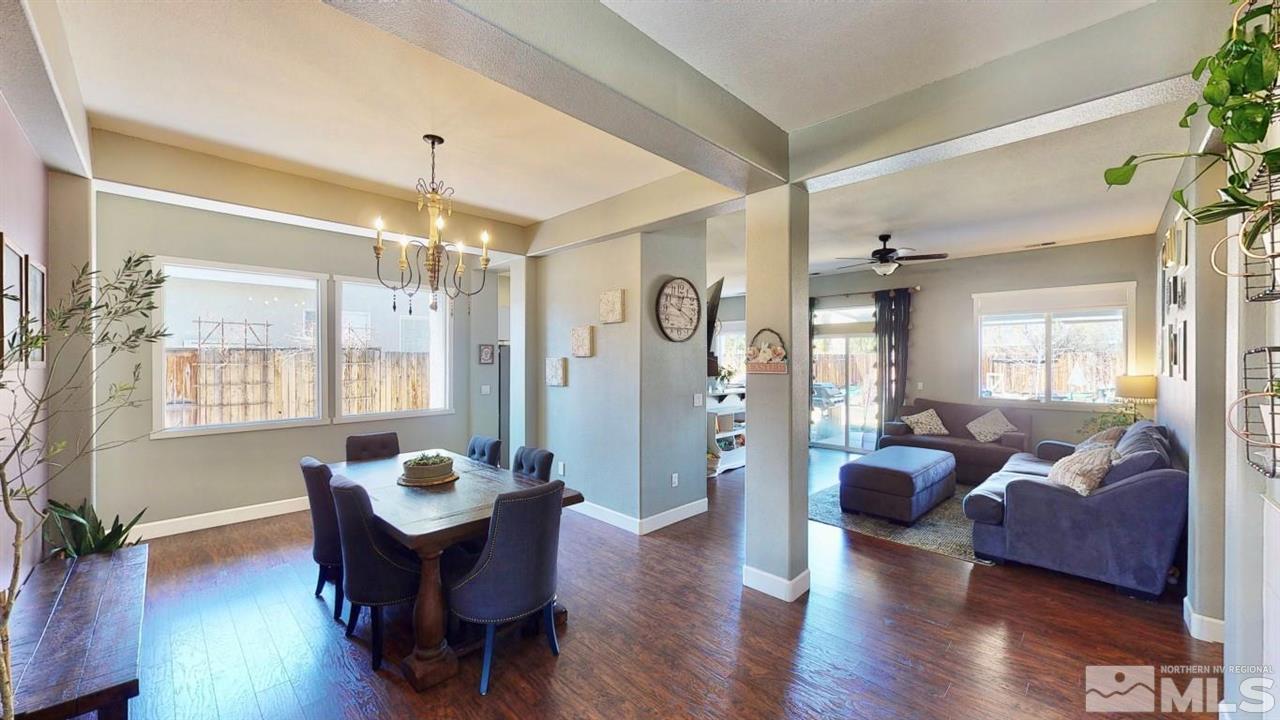 10621 Copper Moon Court Reno, NV 89521 - Photo 3 of 33 a living room with furniture a chandelier and a dining table