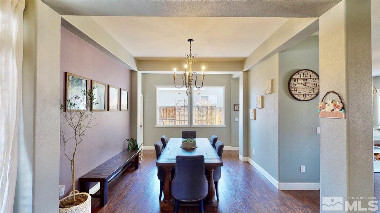 10621 Copper Moon Court Reno, NV 89521 - Photo 4 of 33 a dining room with furniture a chandelier and wooden floor