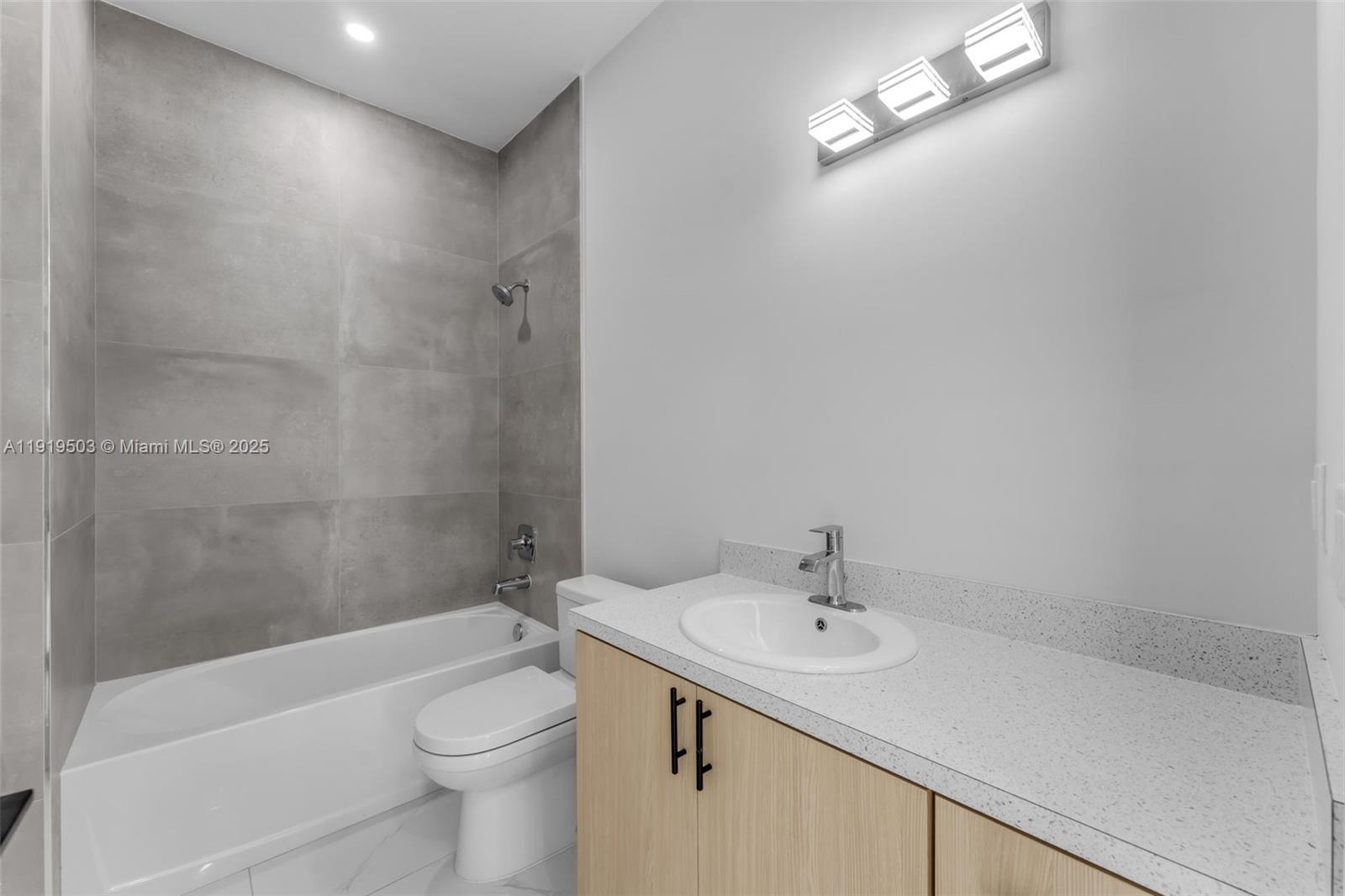 12393 Southwest 220th Street Miami, FL 33170 - Photo 12 of 22 a bathroom with a sink a toilet and shower