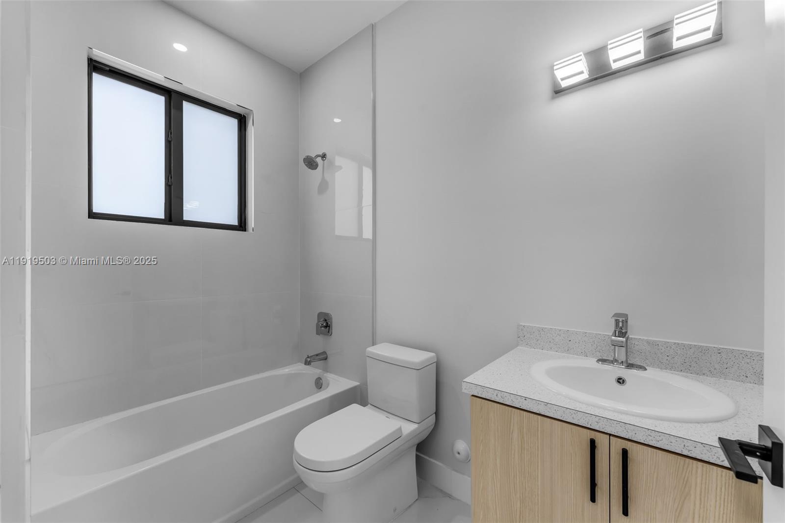 12393 Southwest 220th Street Miami, FL 33170 - Photo 15 of 22 a bathroom with a toilet a sink a mirror and a bathtub