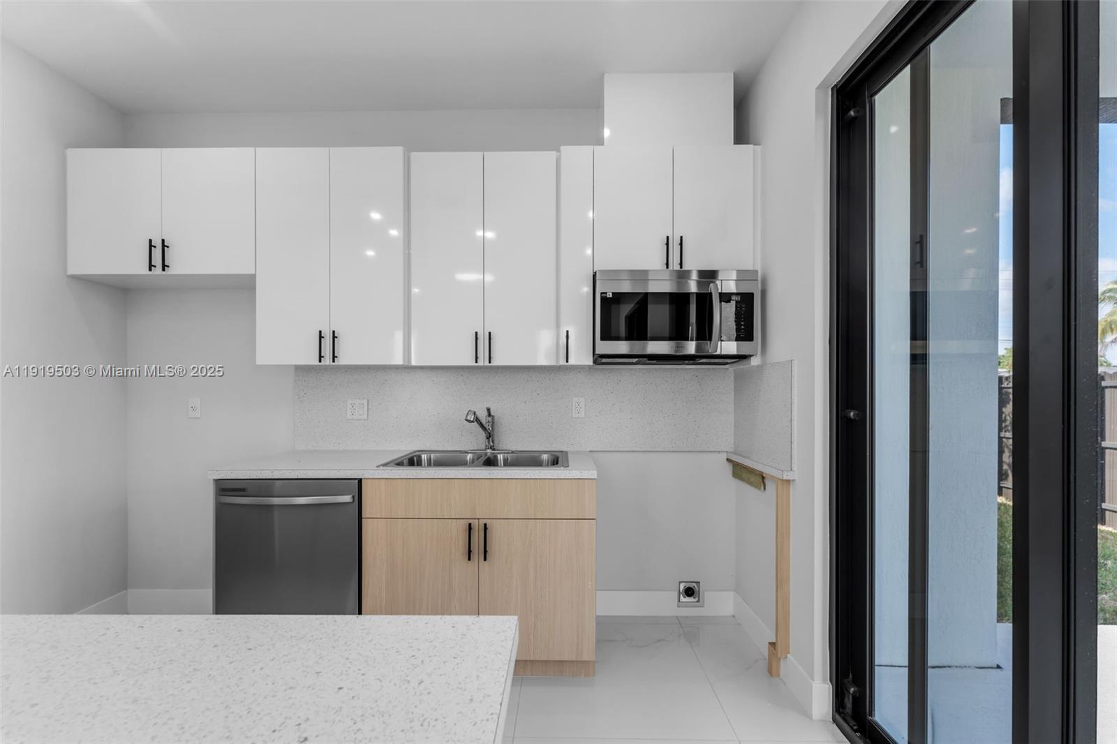12393 Southwest 220th Street Miami, FL 33170 - Photo 6 of 22 a kitchen with a sink and cabinets