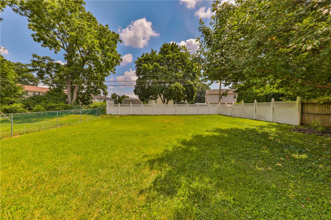 3050 Cornwall Road Bethlehem, PA 18017 - Photo 70 of 80 A generous, green yard is fully enclosed by secure fencing, offering privacy and space.