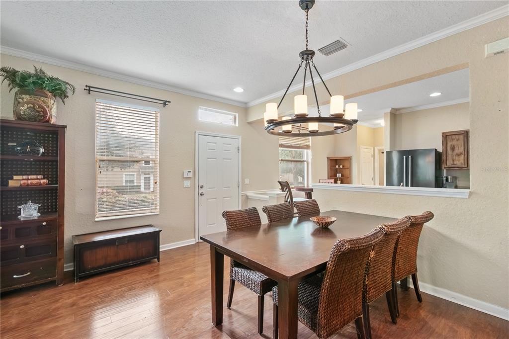 4122 Southwest 54th Circle Ocala, FL 34474 - Photo 14 of 47 a dining room with wooden floor a chandelier a wooden table and chairs