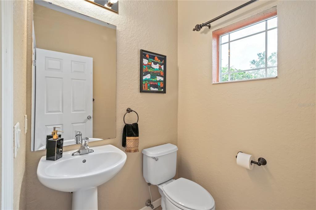 4122 Southwest 54th Circle Ocala, FL 34474 - Photo 20 of 47 a bathroom with a toilet sink and mirror