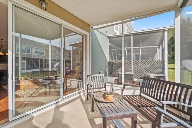 a view of a chair and tables in the patio