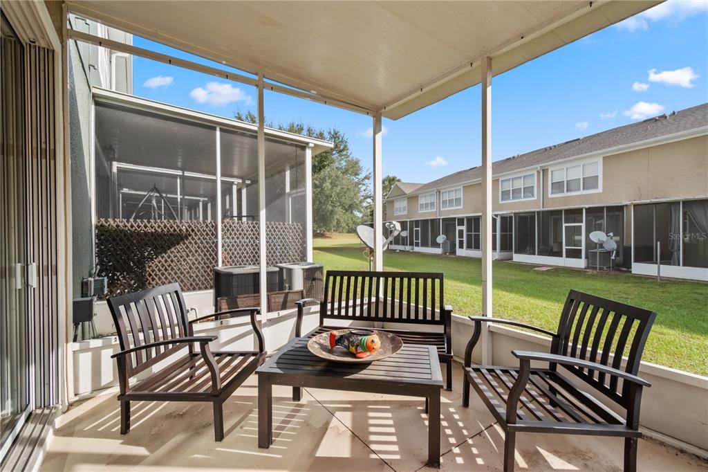 4122 Southwest 54th Circle Ocala, FL 34474 - Photo 22 of 47 a view of a chair and tables in the patio
