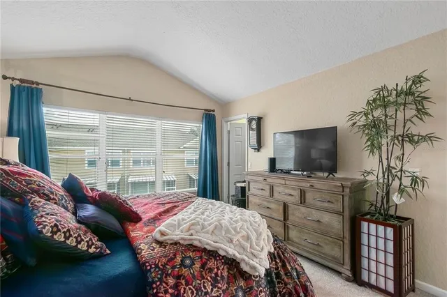 a bedroom with a bed and flat screen tv