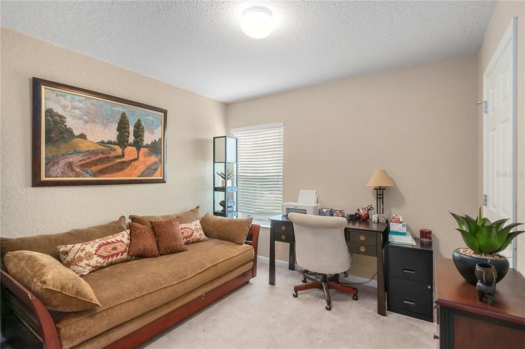 4122 Southwest 54th Circle Ocala, FL 34474 - Photo 27 of 47 a living room with furniture and a potted plant