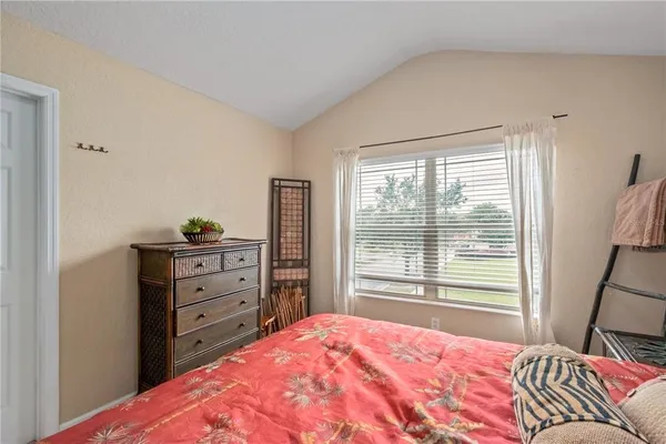 a bedroom with a large bed and a large window