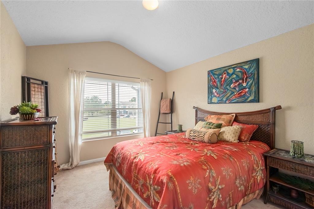 4122 Southwest 54th Circle Ocala, FL 34474 - Photo 33 of 47 a bedroom with a large bed and a large window