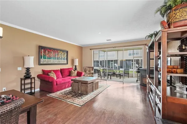 a living room with furniture and a wooden floor