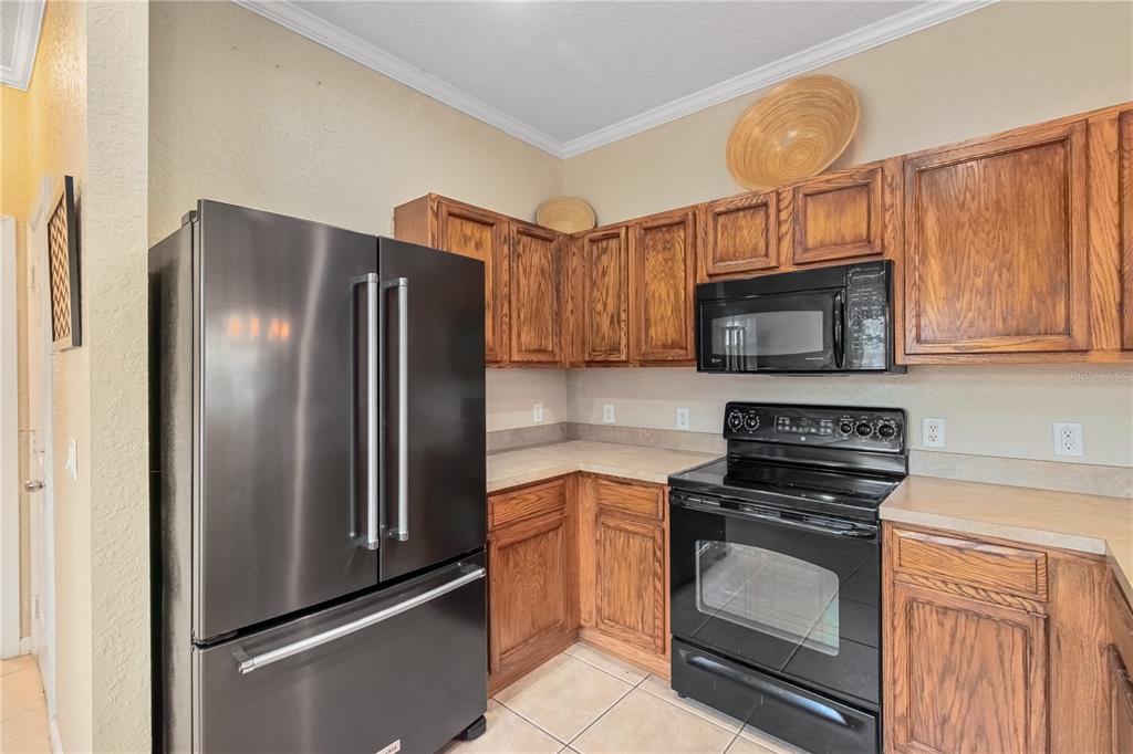 4122 Southwest 54th Circle Ocala, FL 34474 - Photo 8 of 47 a kitchen with stainless steel appliances granite countertop a refrigerator stove and microwave
