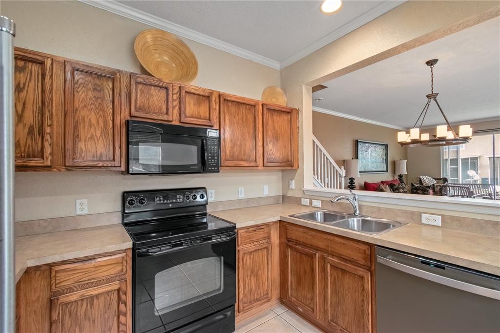 4122 Southwest 54th Circle Ocala, FL 34474 - Photo 9 of 47 a kitchen with stainless steel appliances a stove a sink and a microwave
