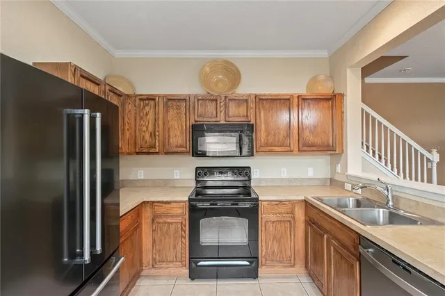 a kitchen with granite countertop stainless steel appliances and wooden cabinets