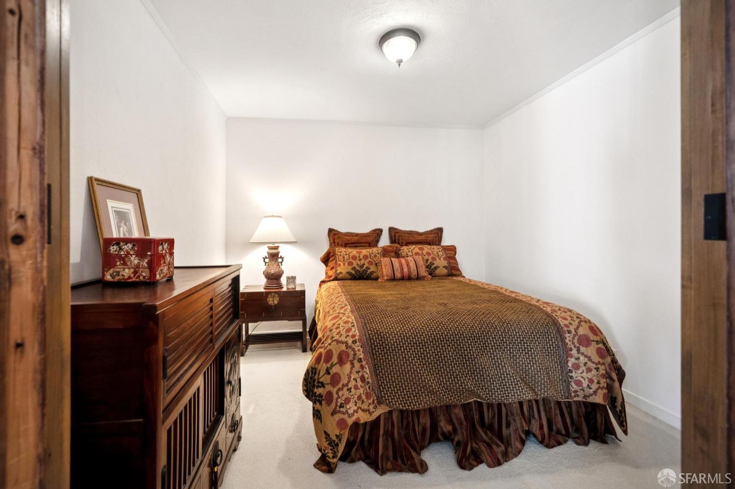 2200 Pacific Avenue, Unit 8E San Francisco, CA 94115 - Photo 15 of 36 a bedroom with a bed and wooden floor