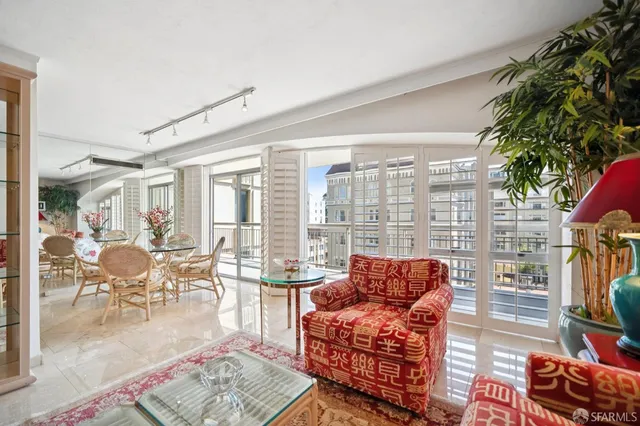 a living room filled with furniture and a potted plant