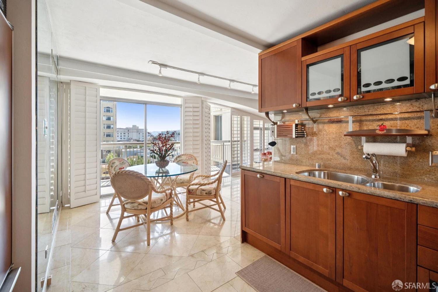 2200 Pacific Avenue, Unit 8E San Francisco, CA 94115 - Photo 6 of 36 a dining hall with stainless steel appliances granite countertop a sink and cabinets