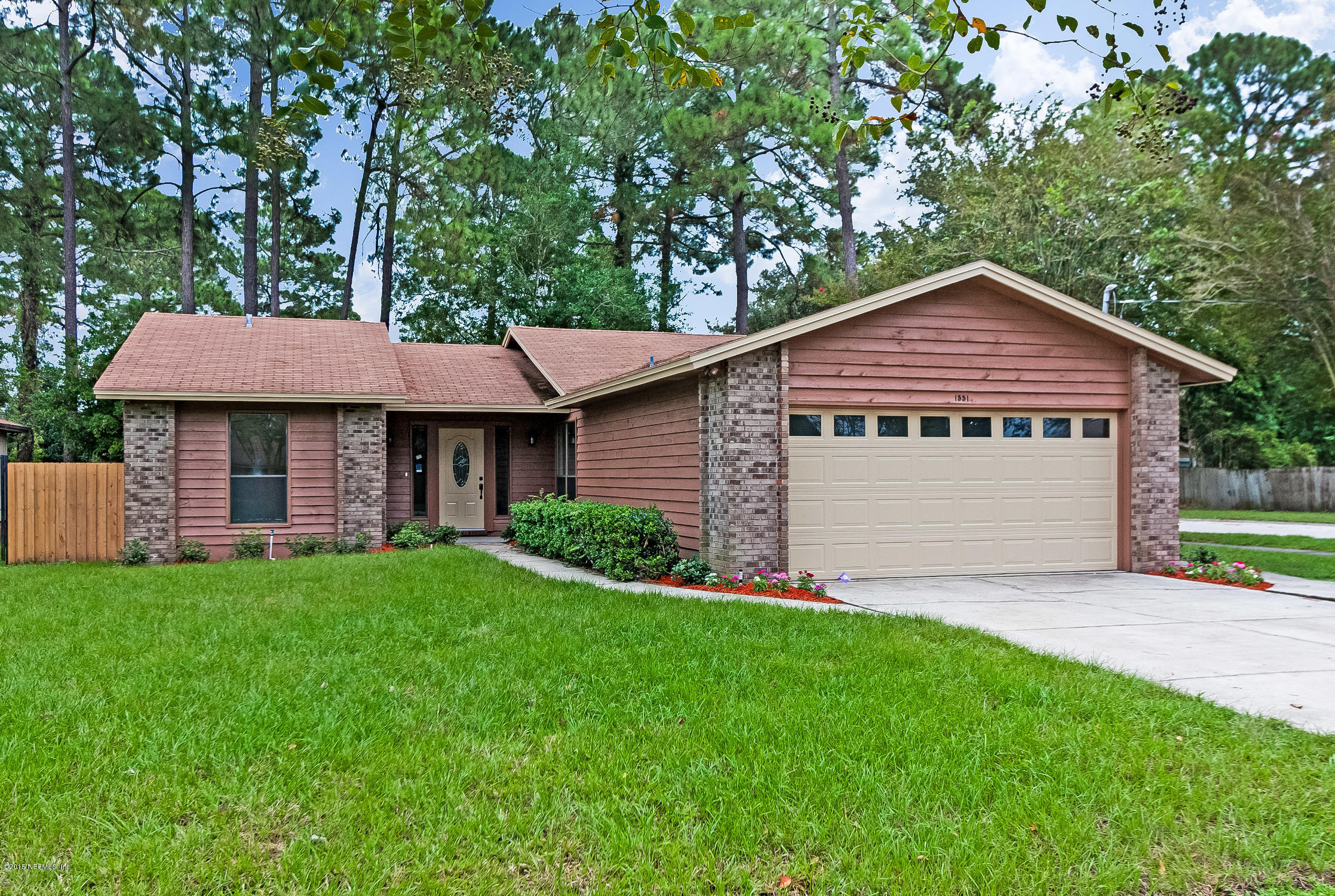 1551 Derringer Road Jacksonville, FL 32225 - Photo 1 of 27 a front view of a house with a garden and yard