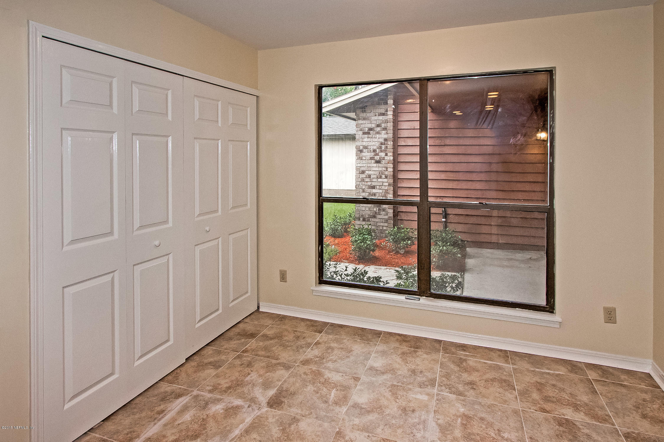 1551 Derringer Road Jacksonville, FL 32225 - Photo 11 of 27 an empty room with windows and entrance