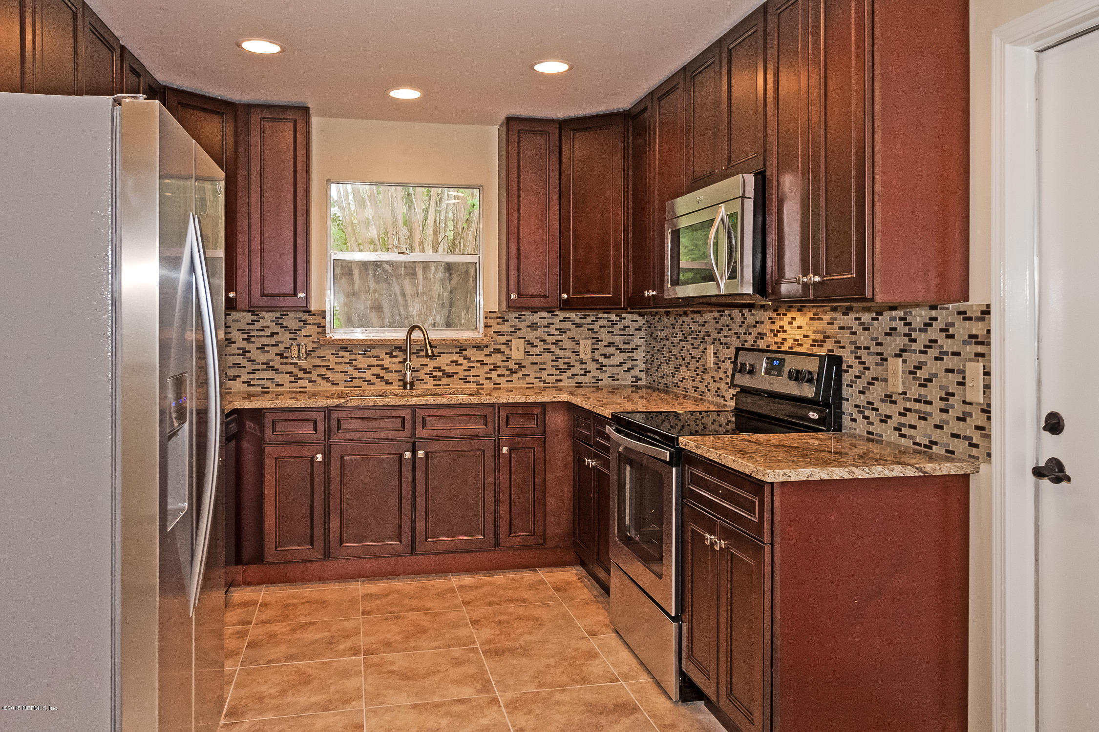1551 Derringer Road Jacksonville, FL 32225 - Photo 12 of 27 a kitchen with stainless steel appliances granite countertop a sink stove and refrigerator
