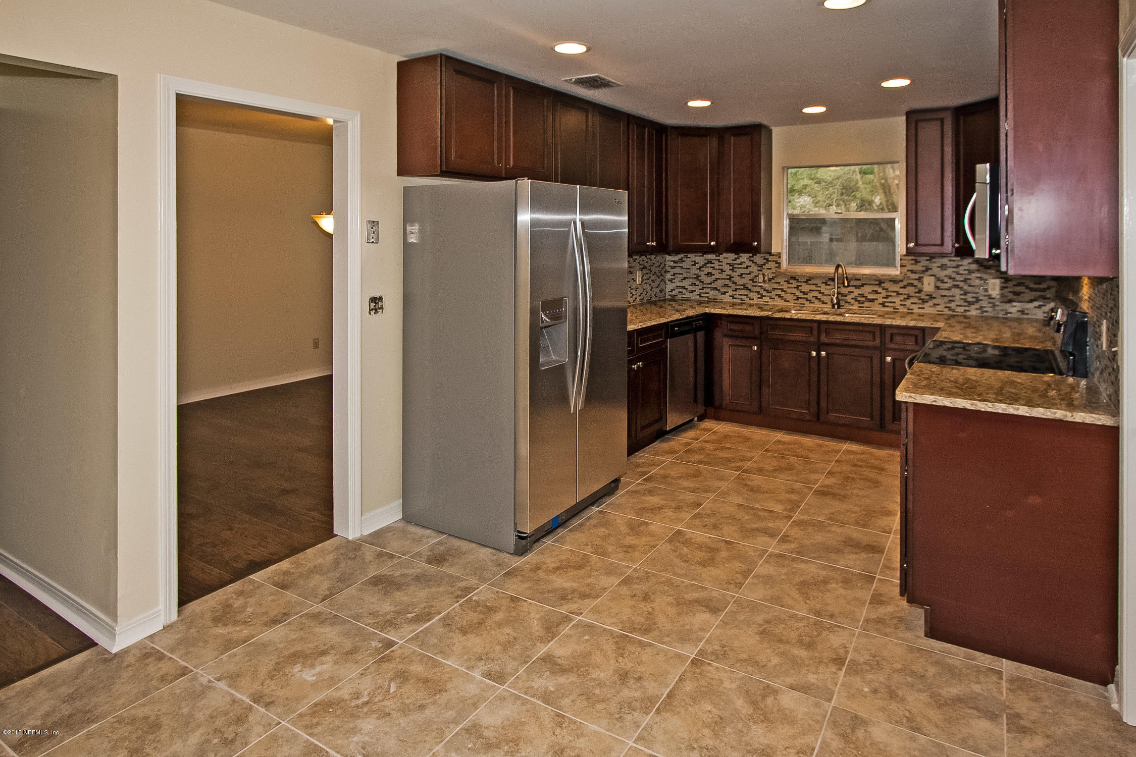 1551 Derringer Road Jacksonville, FL 32225 - Photo 15 of 27 a kitchen with granite countertop stainless steel appliances a refrigerator and a stove