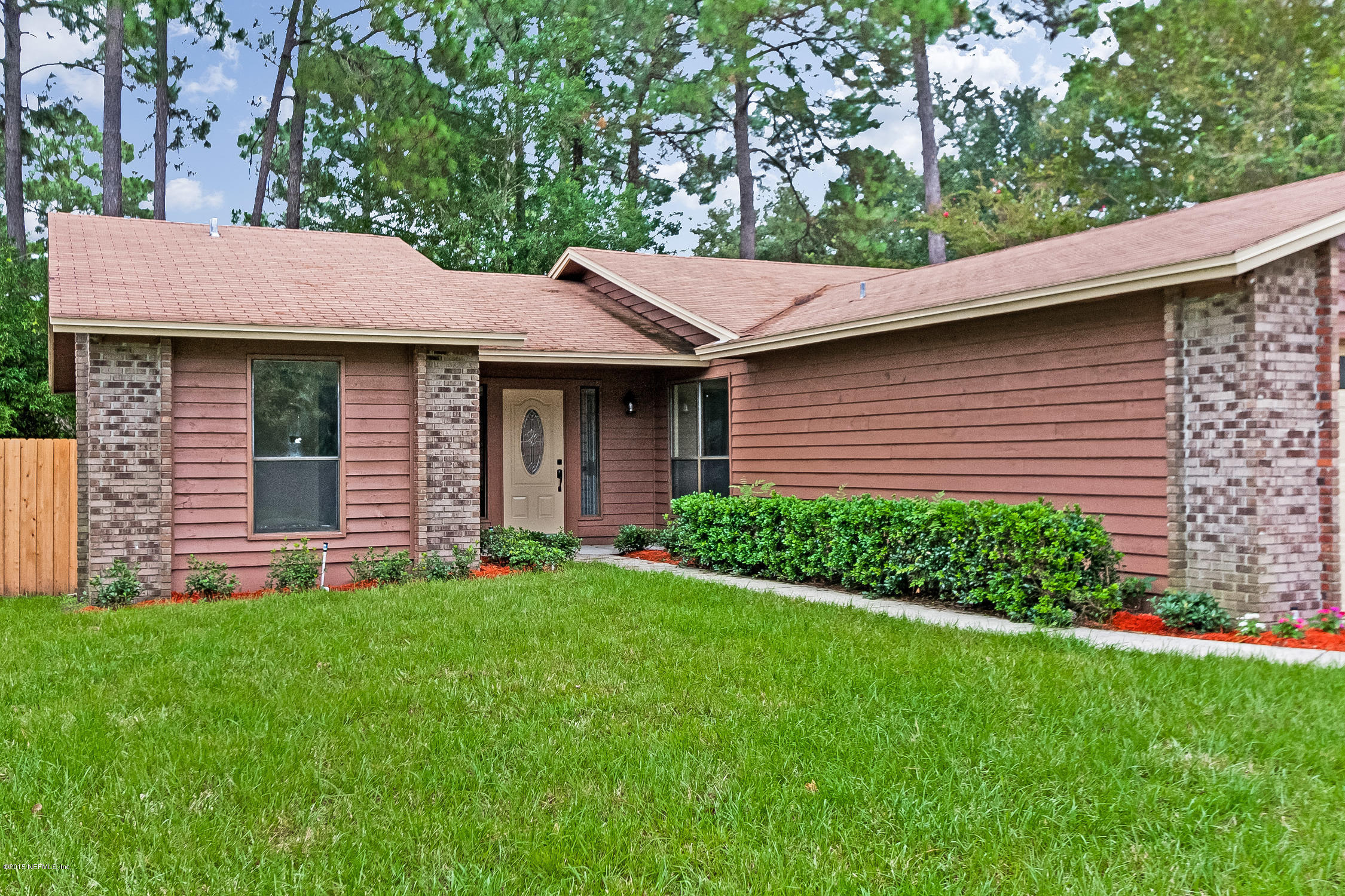 1551 Derringer Road Jacksonville, FL 32225 - Photo 3 of 27 a brick house with a garden view