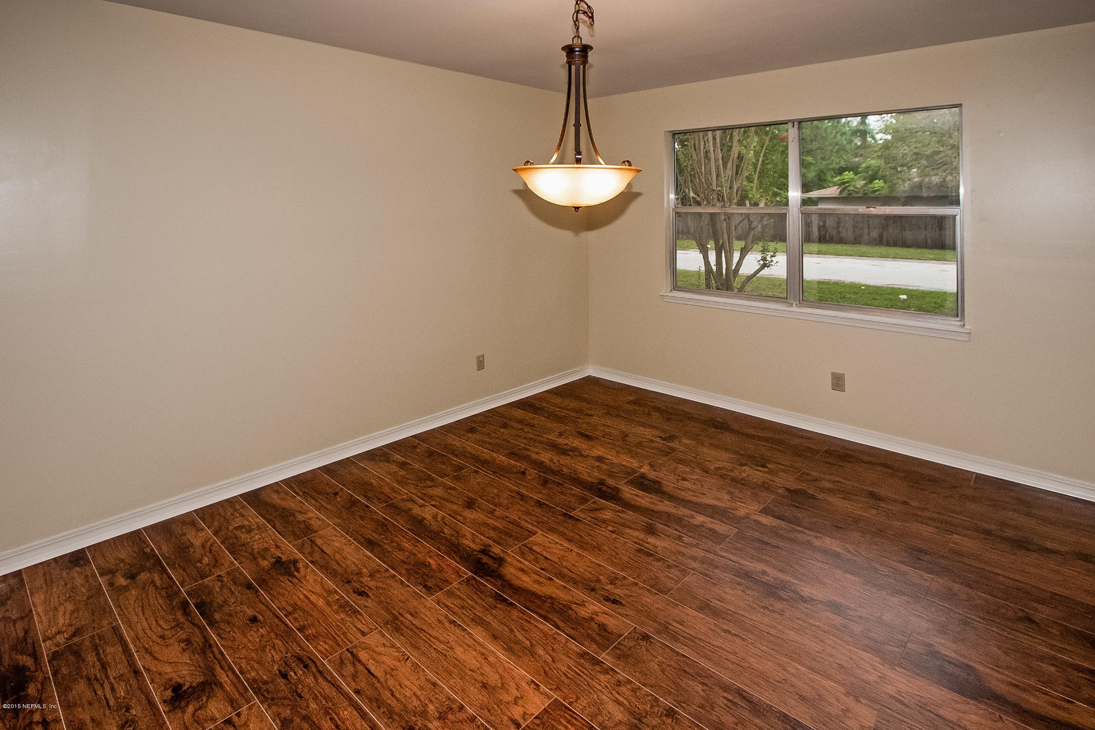 1551 Derringer Road Jacksonville, FL 32225 - Photo 10 of 27 a view of a room with wooden floor and windows
