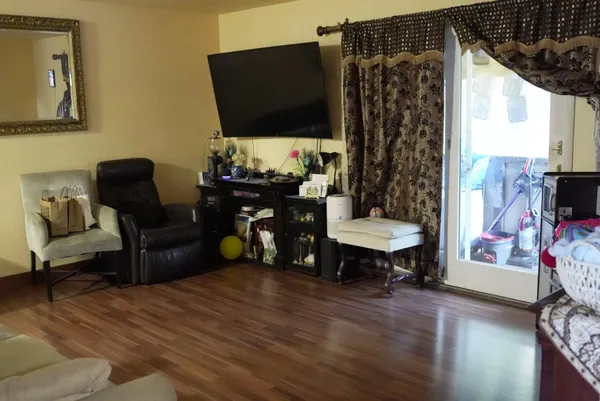 a living room with furniture and a flat screen tv