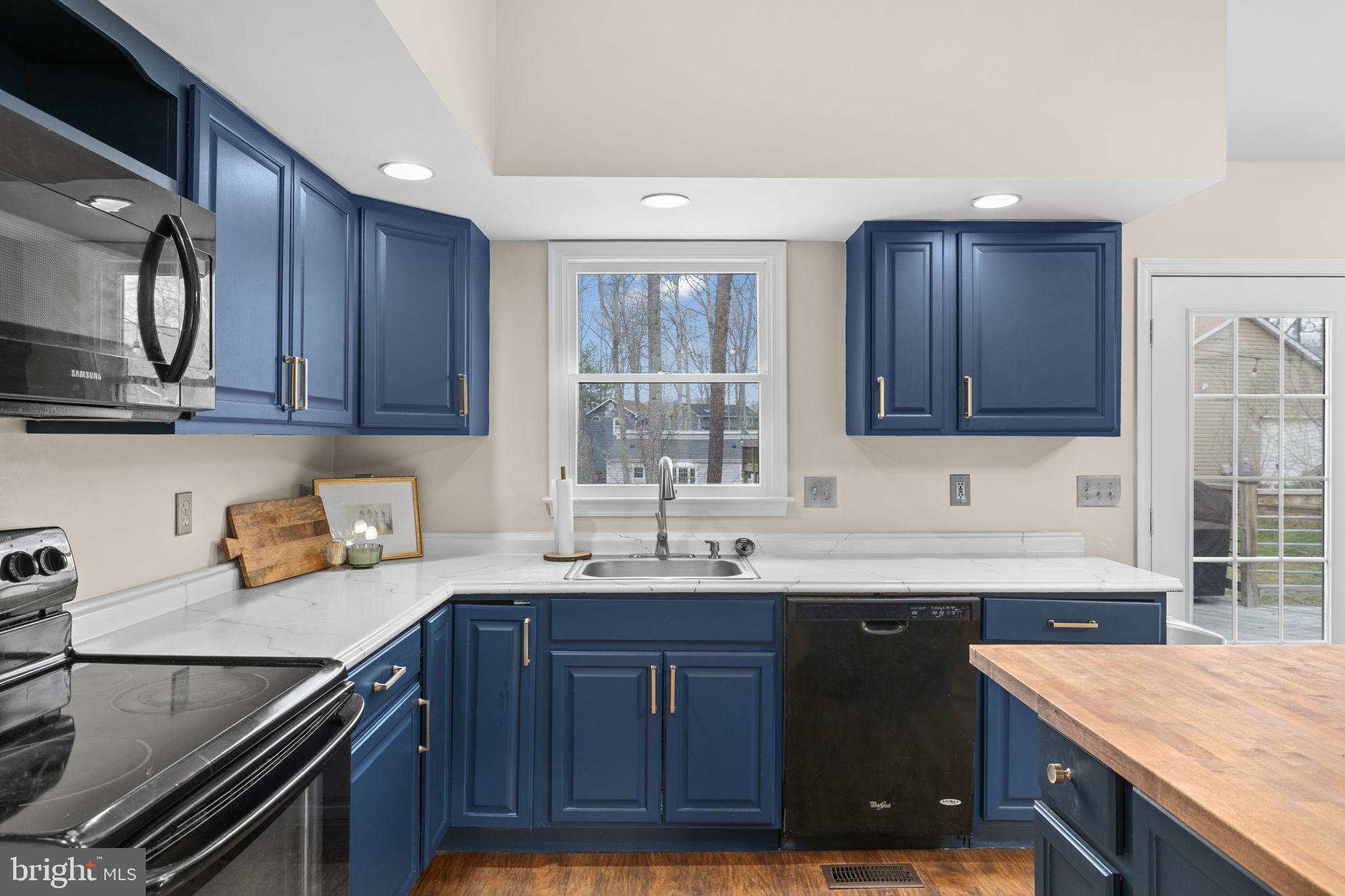 200 Wilderness Lane Locust Grove, VA 22508 - Photo 11 of 67 Chic kitchen with navy cabinetry.