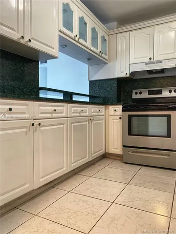 a kitchen with cabinets and appliances