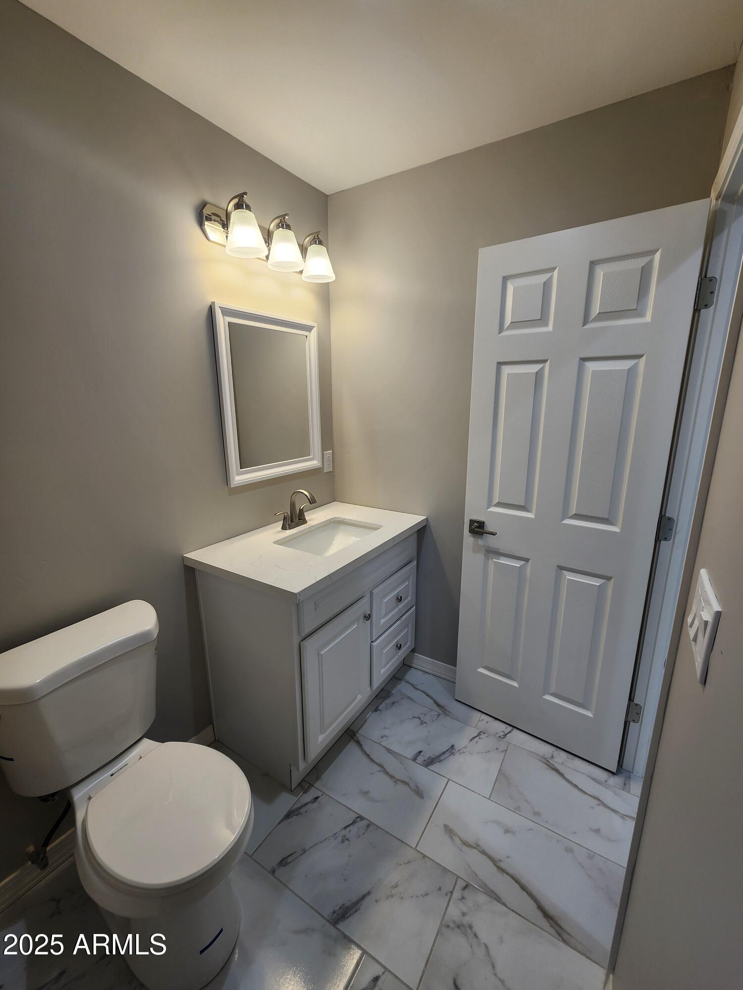 8838 North 2nd Way Phoenix, AZ 85020 - Photo 11 of 16 a bathroom with a toilet sink and mirror