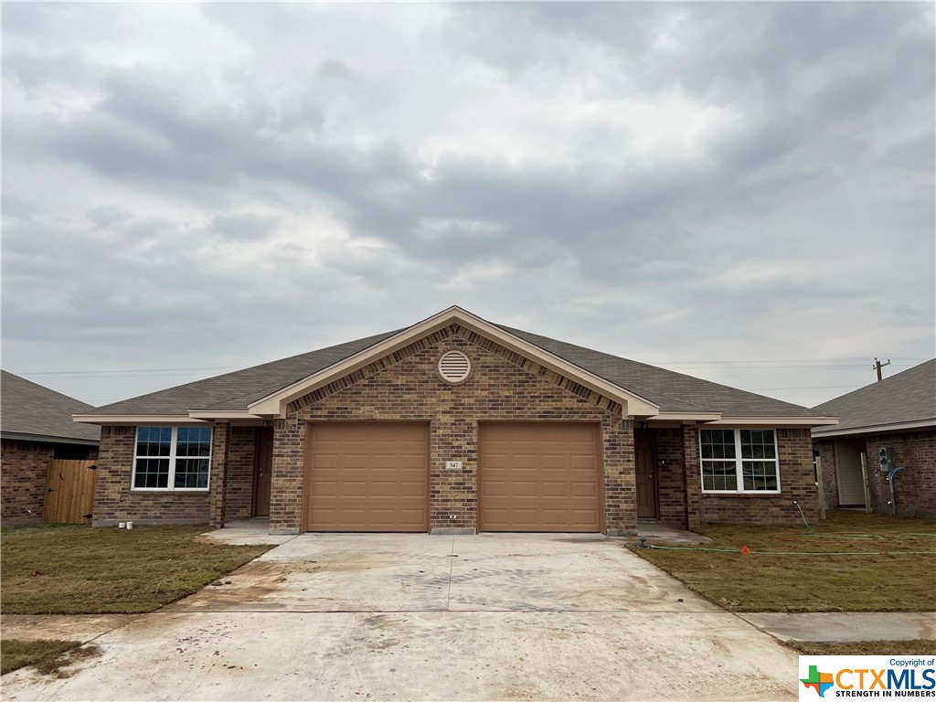a front view of a house with yard