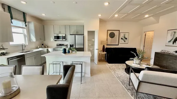 a living room with furniture a fireplace and a large window