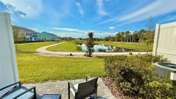 a view of a swimming pool and an outdoor seating