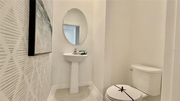 a bathroom with a sink toilet and a mirror