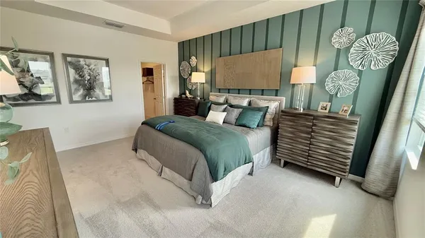 a bedroom with a bed and a painting on the wall