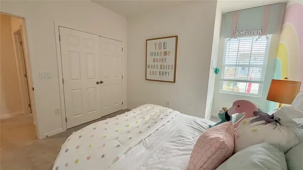 a bedroom with a bed and a painting on the wall