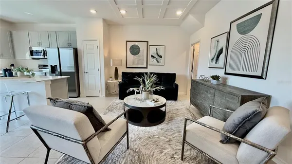 a living room with furniture and kitchen view