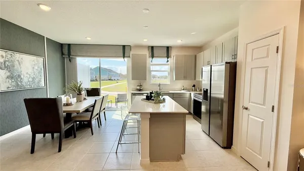 a large kitchen with a table and chairs