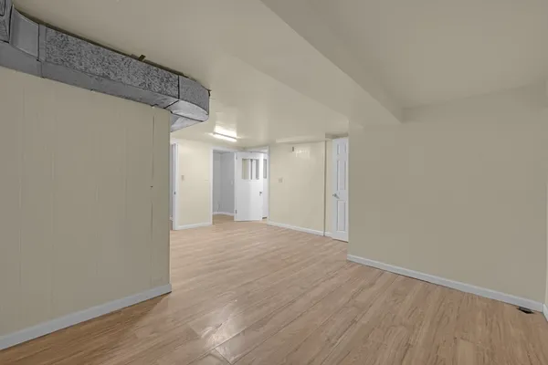 a view of a room with wooden floor