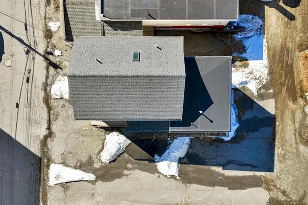 an aerial view of a building with parking space