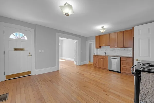 a view of a kitchen with a sink and dishwasher a refrigerator with wooden floor